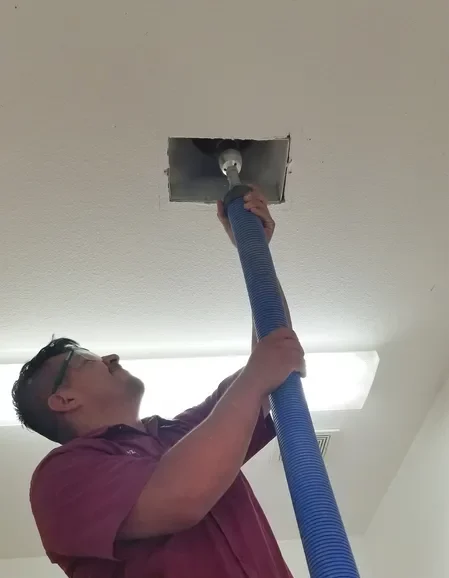 A man is holding the air duct cleaning tool.