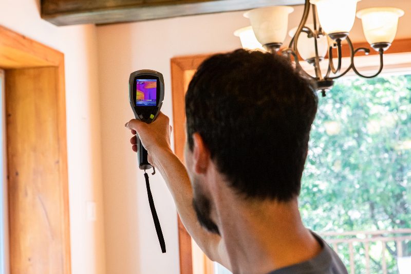 A man holding up a camera to take a picture.