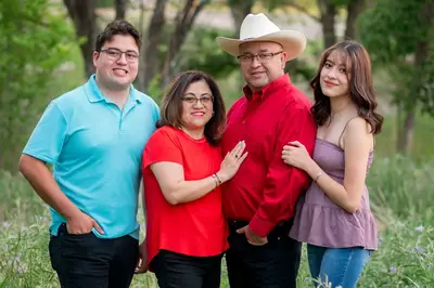 A family posing for a picture in the park.