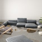 A living room flooded with water and debris.