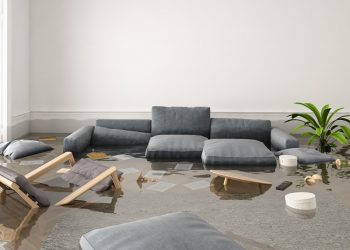 A living room flooded with water and debris.