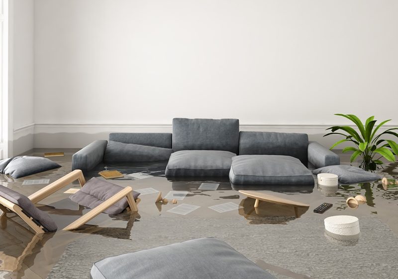 A living room flooded with water and debris.