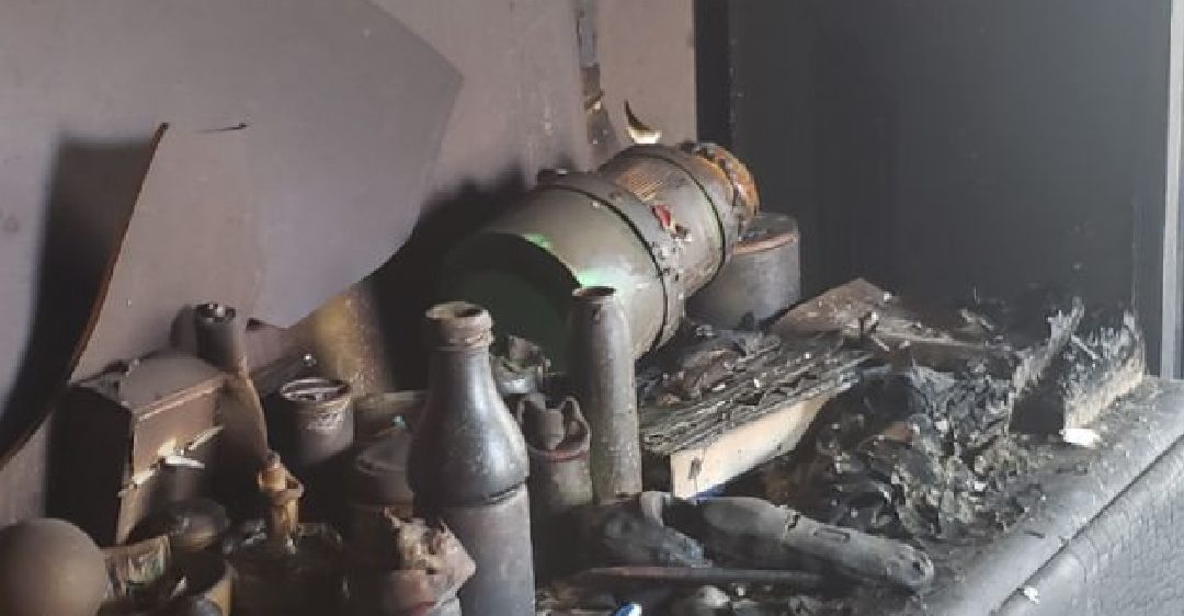 A fireplace with ashes and other items on it.