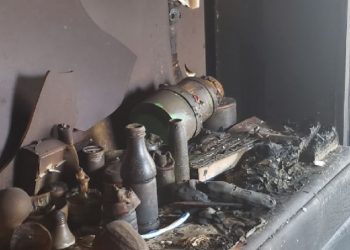 A fireplace with ashes and other items on it.
