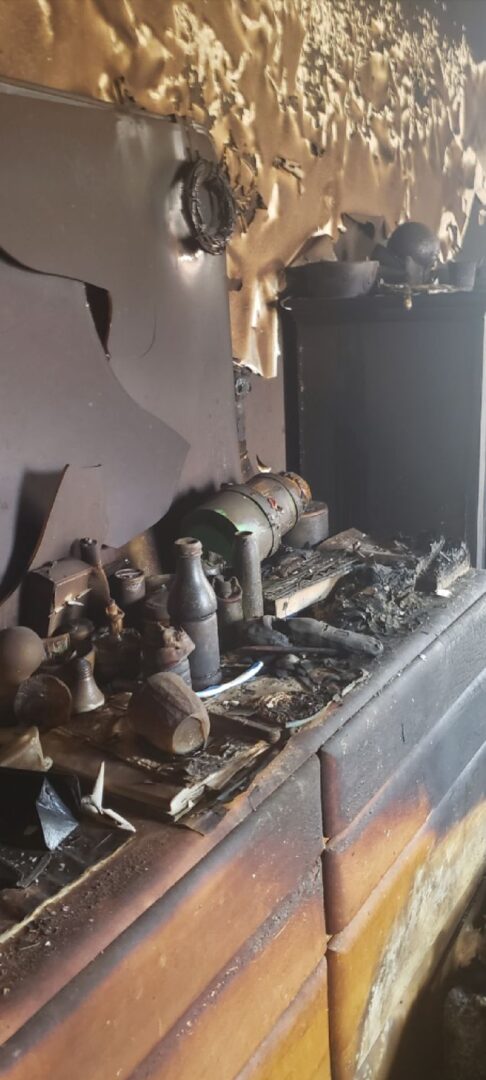 A fireplace with ashes and other items on it.