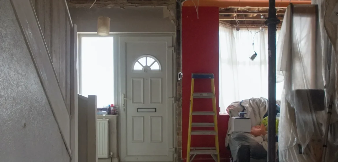 A room with a ladder and some construction materials