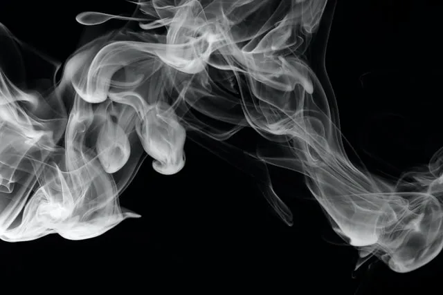 A black and white photo of smoke coming out from the bottom.