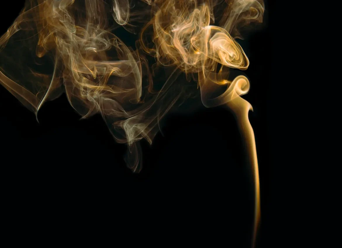A smoke filled with yellow smoke on top of a black background.