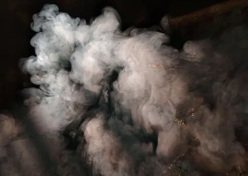 A cloud of smoke is coming out from the ground.