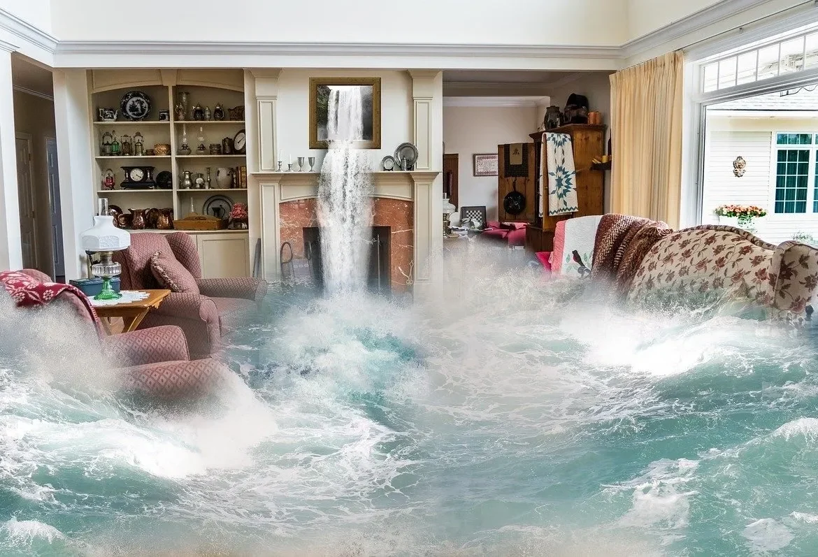 A living room flooded with water from a waterfall.