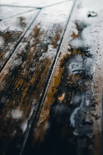 A close up of the wood surface with water on it