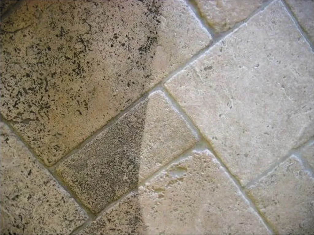 A tile floor with two different colors of grout.