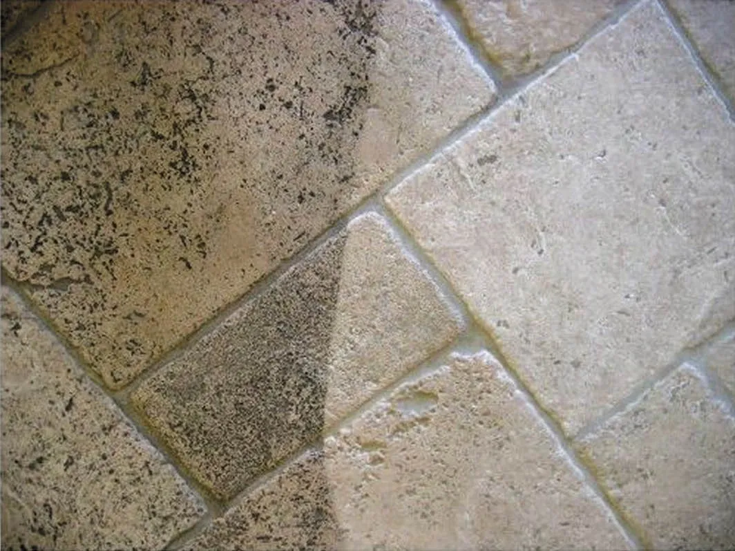 A tile floor with two different colors of grout.