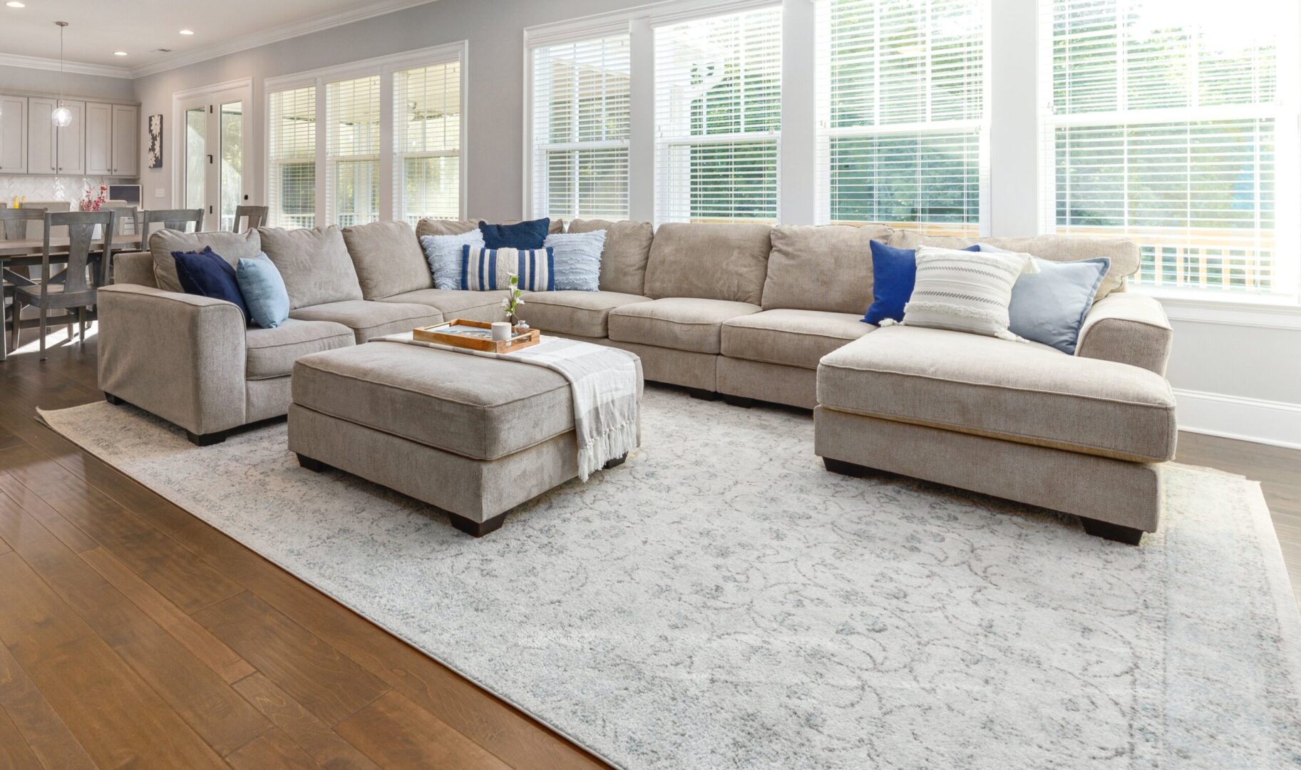 A large living room with couches and pillows on the floor