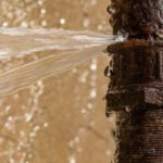 A water spout is seen coming out of the pipe.